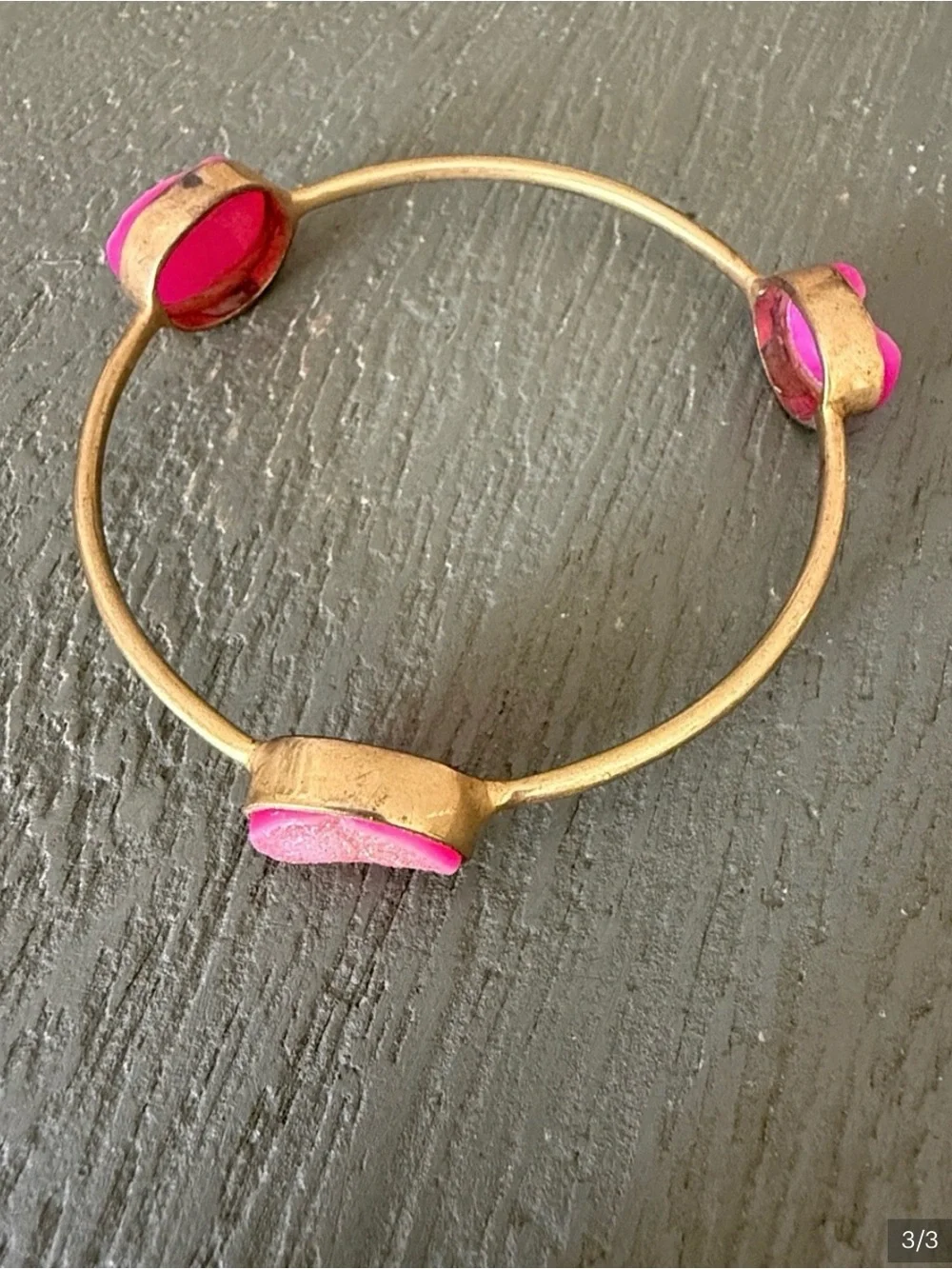 Two pink and gold bracelets